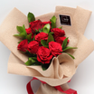 Red roses bouquet in natural burlap wrap with red ribbon
