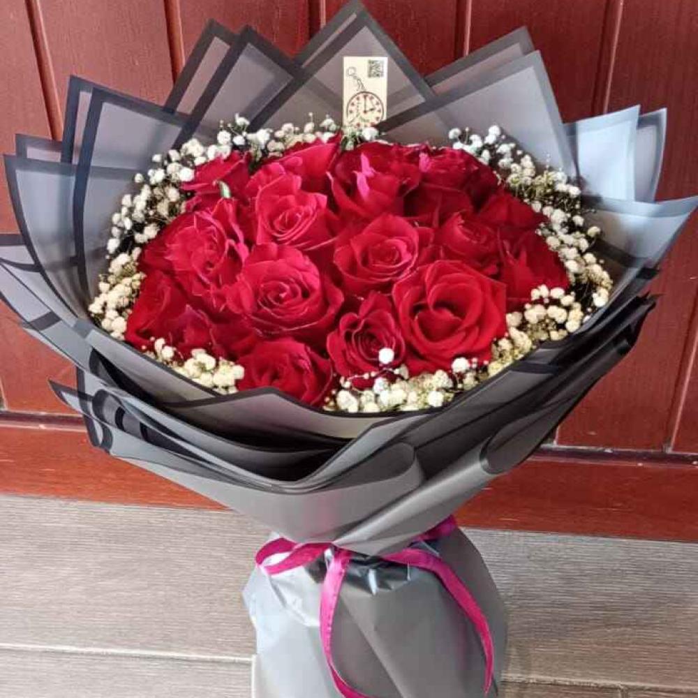 Red roses bouquet with baby's breath in elegant black and silver wrap