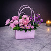 Lavender handbag flower base 14 - pink roses and lily arrangement in a quilted lavender handbag box