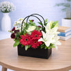 Black handbag flower base 14 - red gerbera and white lily arrangement in a matte black handbag box