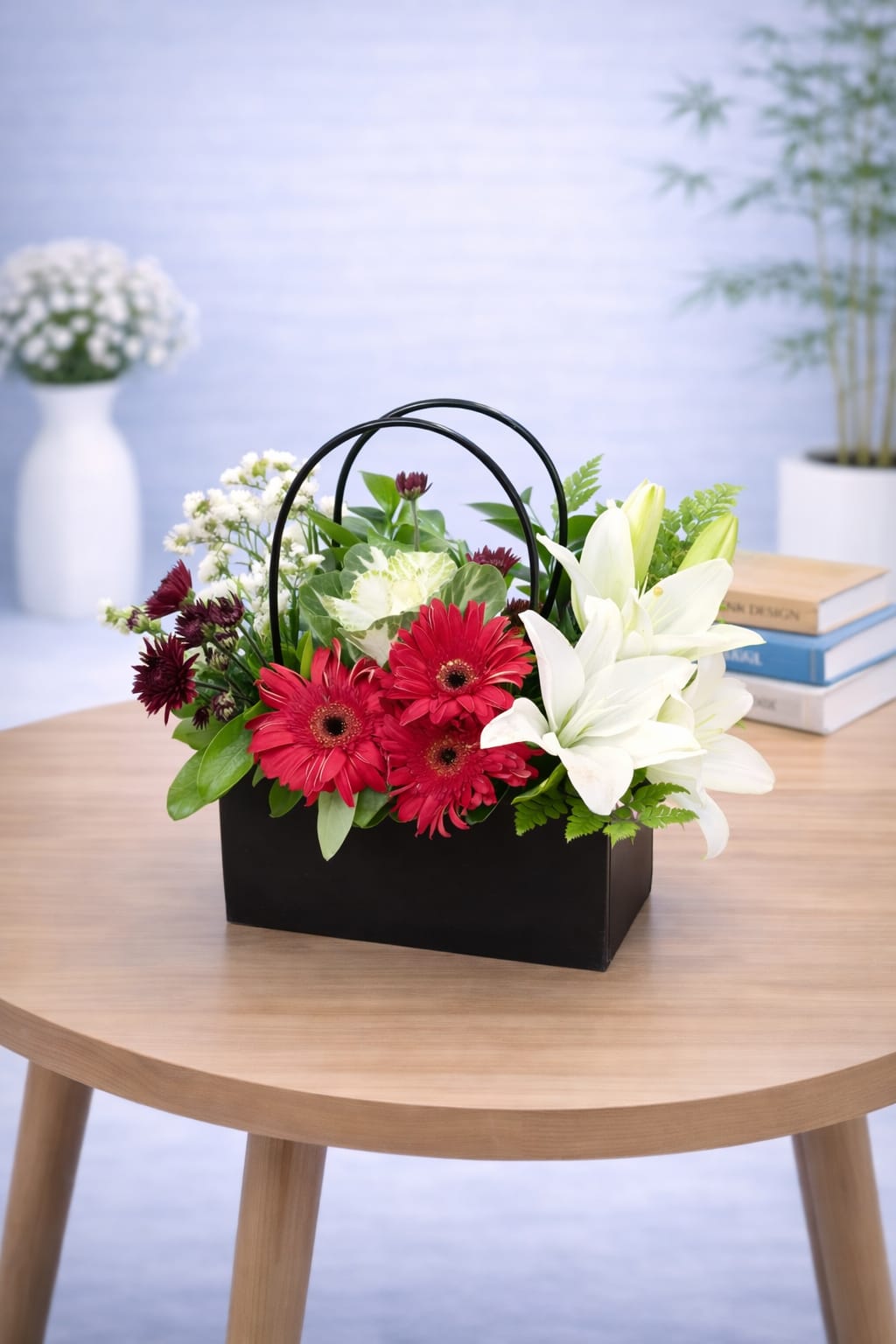 Black handbag flower base 14 - red gerbera and white lily arrangement in a matte black handbag box